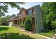 Side view of a brick home featuring manicured lawn and mature trees on a sunny day at 1125 Victoria Blake Ln, Belmont, NC 28012