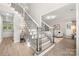Bright foyer with hardwood floors and staircase with decorative spindles and wood accents at 1125 Victoria Blake Ln, Belmont, NC 28012