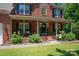Inviting front porch with black shutters, black railing, and well-maintained landscaping at 1125 Victoria Blake Ln, Belmont, NC 28012