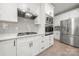 Modern kitchen with white cabinets, stainless steel appliances, subway tile backsplash, and gas cooktop at 1125 Victoria Blake Ln, Belmont, NC 28012