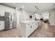 Spacious kitchen with stainless steel refrigerator and white island featuring modern black hardware at 1125 Victoria Blake Ln, Belmont, NC 28012