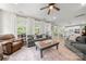 Bright and open living room with large windows, comfortable seating, and view to the kitchen at 1125 Victoria Blake Ln, Belmont, NC 28012