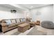 Cozy living area with a plush sectional sofa, ottoman, and decorative pillows in a neutral color palette at 1125 Victoria Blake Ln, Belmont, NC 28012