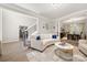 Open-concept living room features a white sofa with blue pillows and access to dining area at 1125 Victoria Blake Ln, Belmont, NC 28012