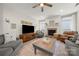 Inviting living room featuring a stone fireplace, ceiling fan, and plush seating at 1125 Victoria Blake Ln, Belmont, NC 28012