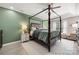 Main bedroom featuring a four-poster bed, tray ceilings, bedside tables, and neutral tones at 1125 Victoria Blake Ln, Belmont, NC 28012