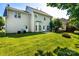 The manicured backyard offers a fire pit, patio doors, grass and landscaping at 119 Tilton Dr, Mooresville, NC 28115
