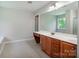 Bright bathroom with double sinks, white countertop, and large mirror at 119 Tilton Dr, Mooresville, NC 28115