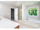 Bright bathroom features a soaking tub under a window and a glass enclosed shower at 119 Tilton Dr, Mooresville, NC 28115