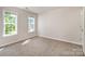 Cozy bedroom with carpet flooring features natural light from two windows at 119 Tilton Dr, Mooresville, NC 28115