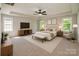 Relaxing main bedroom with tray ceiling, a ceiling fan, and ample natural light at 119 Tilton Dr, Mooresville, NC 28115