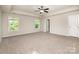 Expansive bedroom offers plush carpet, bright windows and ceiling fan at 119 Tilton Dr, Mooresville, NC 28115