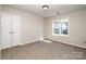 This bedroom features neutral walls, carpet, closet and a bright window view at 119 Tilton Dr, Mooresville, NC 28115