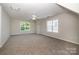 Spacious bonus room features carpet floors, and bright windows with natural light at 119 Tilton Dr, Mooresville, NC 28115