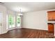 Bright dining area features wood floors, a modern chandelier, and sunny windows at 119 Tilton Dr, Mooresville, NC 28115