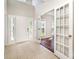 Bright foyer with tile flooring, high ceilings, and glass doors leading to an adjacent room with wood floors at 119 Tilton Dr, Mooresville, NC 28115
