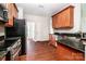 Well-lit kitchen boasts stainless appliances, granite counters, and wood floors at 119 Tilton Dr, Mooresville, NC 28115