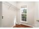 Functional laundry room featuring wood floors, shelving, and a window at 119 Tilton Dr, Mooresville, NC 28115
