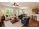 Cozy living room with hardwood floors, a comfortable sofa, and a view of the backyard at 119 Tilton Dr, Mooresville, NC 28115