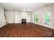 Spacious living room featuring a fireplace, built-in shelves, wood flooring, and a backyard view at 119 Tilton Dr, Mooresville, NC 28115