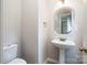 Cozy powder room with pedestal sink and a large octagon mirror at 119 Tilton Dr, Mooresville, NC 28115