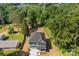 Aerial view of a two-story house with a gray roof and siding, surrounded by mature trees and a well-maintained lawn at 1227 Breezewood Dr, Charlotte, NC 28262