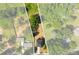 An aerial view highlighting the property lines of a gray two-story home encircled by an abundance of trees at 1227 Breezewood Dr, Charlotte, NC 28262