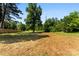 An empty backyard shows freshly tilled earth and a new fence line, ready for landscaping at 1227 Breezewood Dr, Charlotte, NC 28262