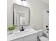 Bathroom with a white vanity, black fixtures, a large mirror and tiled shower and view to kitchen at 1227 Breezewood Dr, Charlotte, NC 28262