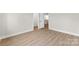 A bright, empty bedroom features a neutral color scheme and light wood-look flooring at 1227 Breezewood Dr, Charlotte, NC 28262