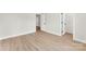 Bright empty bedroom features a neutral color scheme, light wood-look flooring, and a walk-in closet at 1227 Breezewood Dr, Charlotte, NC 28262