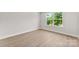 Bright bedroom with natural light streaming through the windows and wood flooring at 1227 Breezewood Dr, Charlotte, NC 28262