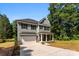 Well-maintained two-story home featuring neutral siding, a covered porch, a two-car garage, and a spacious driveway at 1227 Breezewood Dr, Charlotte, NC 28262