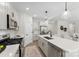 Bright kitchen with stainless steel appliances, white cabinetry, island with a sink and pendant lighting at 1227 Breezewood Dr, Charlotte, NC 28262