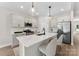 Modern kitchen featuring white cabinets, stainless steel appliances, pendant lighting, and a center island with bar stools at 1227 Breezewood Dr, Charlotte, NC 28262