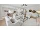 Open-concept living room flowing into dining area, featuring hardwood floors, natural light and modern furnishings at 1227 Breezewood Dr, Charlotte, NC 28262
