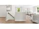 Inviting loft space showcasing staircase, comfortable seating, natural light, and stylish decor at 1227 Breezewood Dr, Charlotte, NC 28262