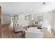 Open-concept loft area featuring plush seating, hardwood floors, and large windows with scenic views at 1227 Breezewood Dr, Charlotte, NC 28262