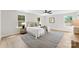 Bright bedroom with a ceiling fan, large windows, and neutral décor creating a relaxing atmosphere at 1227 Breezewood Dr, Charlotte, NC 28262