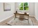 Office featuring a rustic desk, neutral rug, and a large window offering natural light and green views at 1227 Breezewood Dr, Charlotte, NC 28262