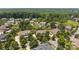 Aerial view of homes and landscaping in a suburban neighborhood featuring mature trees and private backyards at 125 Snow Fountain Ln, Mooresville, NC 28115