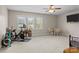Bonus room with windows, a ceiling fan, exercise equipment and a small dining set at 125 Snow Fountain Ln, Mooresville, NC 28115