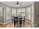 Sun-lit breakfast nook with bay windows features hardwood floors and stylish furnishings at 125 Snow Fountain Ln, Mooresville, NC 28115
