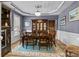 Formal dining room with wainscoting, tray ceiling, chandelier, and ample seating at 125 Snow Fountain Ln, Mooresville, NC 28115