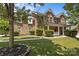 Beautiful brick home with lush green lawn, mature trees, and a welcoming front porch at 125 Snow Fountain Ln, Mooresville, NC 28115