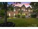 Charming brick home featuring manicured lawn, lush landscaping, and a welcoming front porch at 125 Snow Fountain Ln, Mooresville, NC 28115