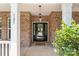 Close up of front door with decorative glass and sidelights, framed by white columns at 125 Snow Fountain Ln, Mooresville, NC 28115