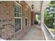 Inviting porch with brick exterior, pendant lights and comfortable seating area at 125 Snow Fountain Ln, Mooresville, NC 28115