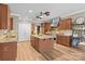 Gourmet kitchen featuring a large island, stainless steel appliances, and wood floors at 125 Snow Fountain Ln, Mooresville, NC 28115