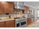 Gourmet kitchen features a professional range, granite countertops and designer backsplash at 125 Snow Fountain Ln, Mooresville, NC 28115